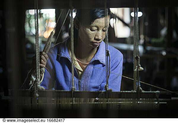 Woman working in weaving manufacture