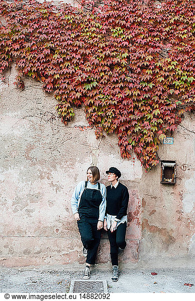 Women beside wall with ivy