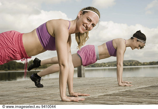 Women exercising on jetty  Woerthsee