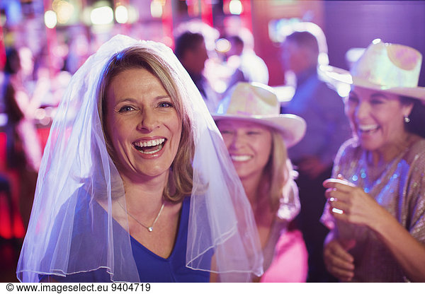 Women having fun at bachelorette party  men in background