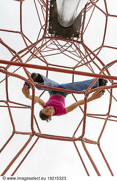 Women having fun on rope equipment under sky