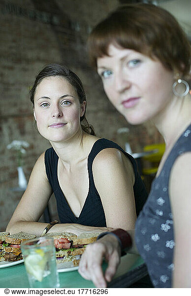 Women Having Sandwiches At Restaurant
