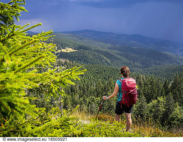Women hiker looking at view of mountain landscape at Col de la Schlucht In the Vosges  Alsace  France