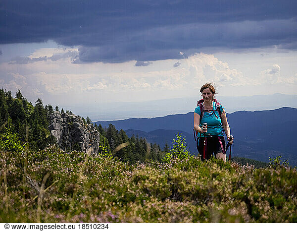 Women hiking on meadow towards valley at Col de la Schlucht In the Vosges  Alsace  France
