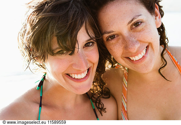 Women in bikinis smiling together
