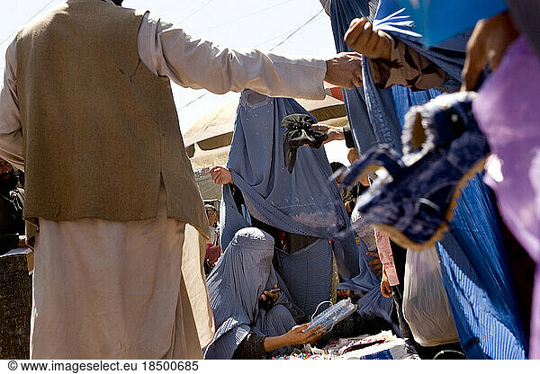 Women in burqas shop for shoes and other goods at Mandawi Market in Kabul.