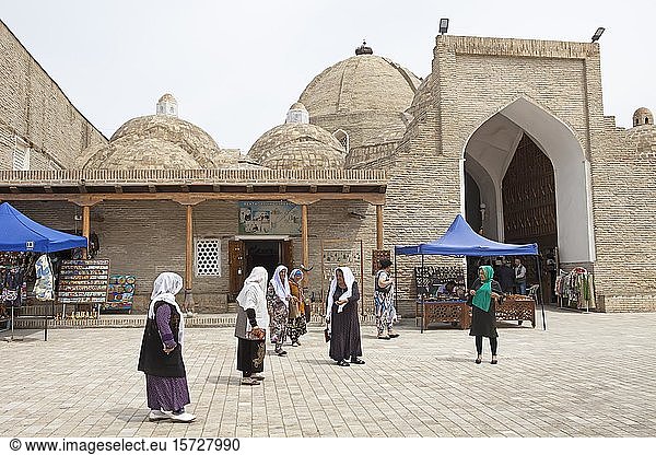 Women in traditional costume at the entrance to the domed bazaars  Old Town Bukhara  Province Buxoro  Uzbekistan  Asia