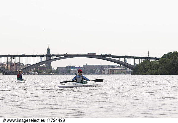 Women kayaking on river