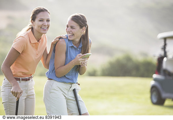 Women laughing on golf course