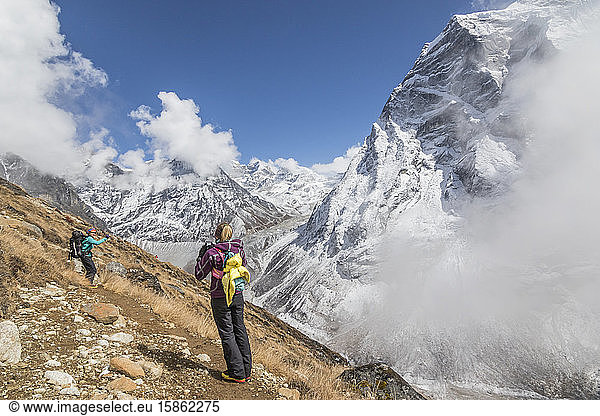 Women mountaineers pose for photos among spectacular mountain backdrop