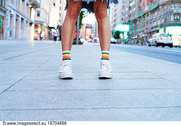 Women's legs in slippers  in the city.