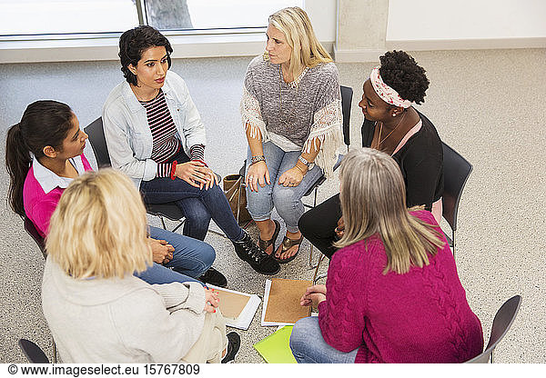 Women's support group talking in circle