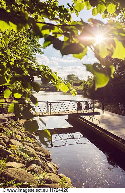 Women sitting on footbridge