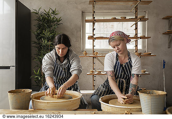 Women using potters wheels