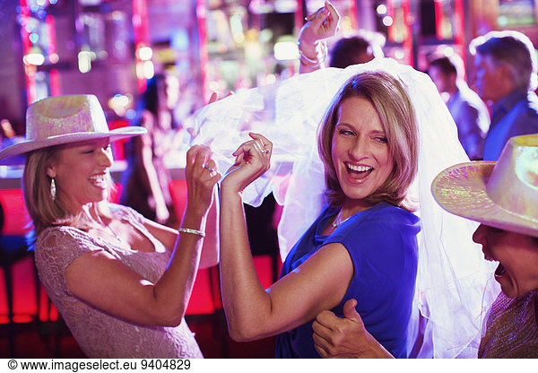 Women wearing hats dancing at bachelorette party