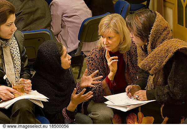 Women work together at a business training seminar in Kabul.