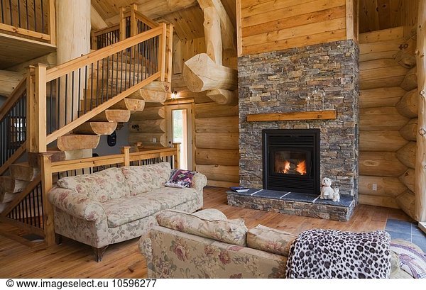 Wood burner in living room of Eastern white pine log cabin