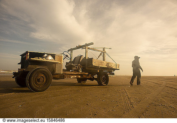 Wood pickup truck and fisherman in the sea shore