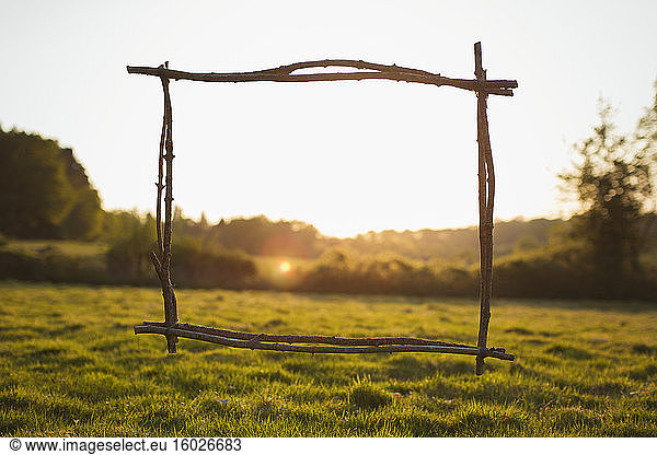 Wood stick frame overlooking sunny tranquil rural view