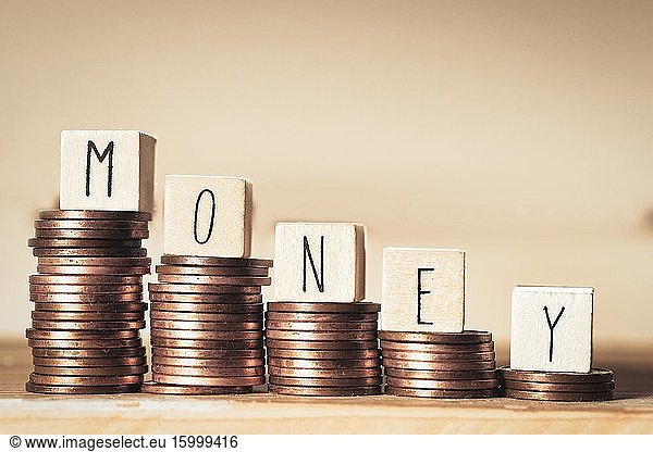 Wooden blocks with the word Money and a pile of coins  Money climbing stairs  business concept background.