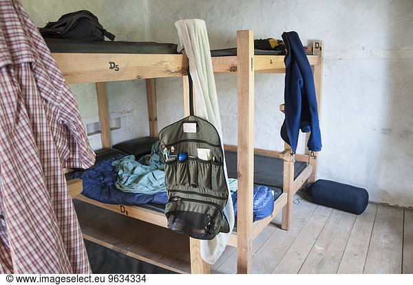 Wooden bunk beds cabin clothes hanging