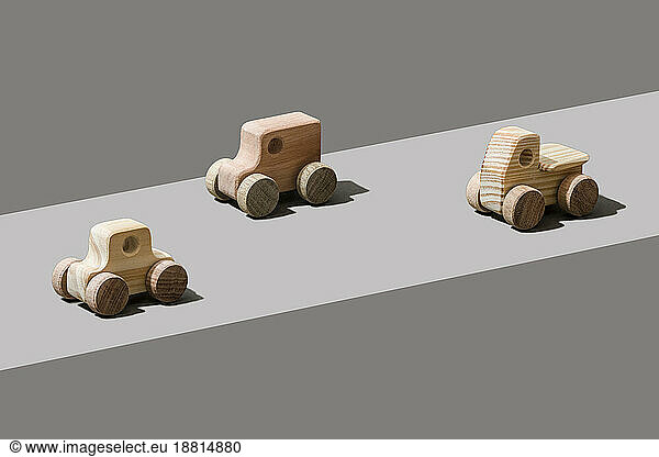 Wooden cars on gray background