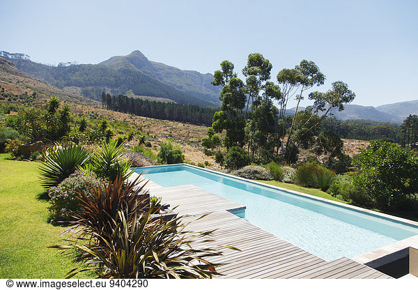 Wooden deck and swimming pool in hilly landscape