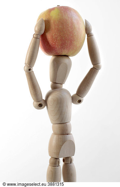 Wooden doll with an apple,  symbolic image for healthy food