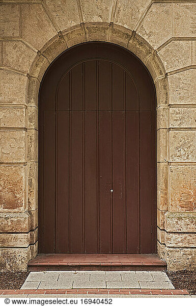 Wooden door in stone arch.