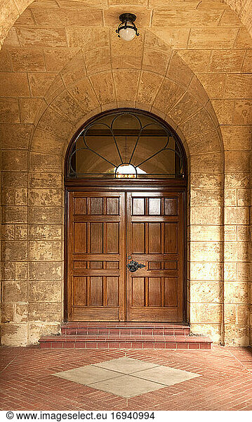 Wooden door in stone arch.