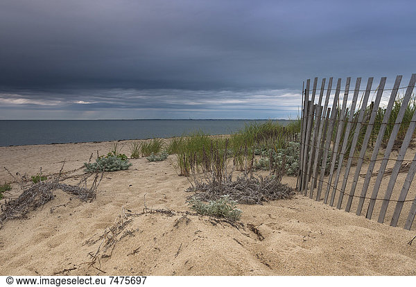 Wooden Fence on Beach with Dark Clouds  Cape Cod  Massachusetts  USA