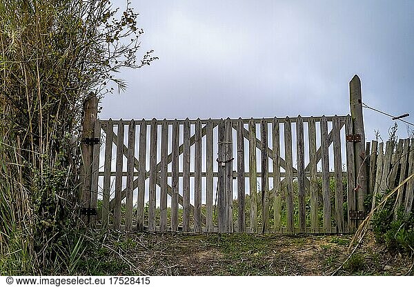 Wooden gate with a padlock leading to the field  Portugal  Europe