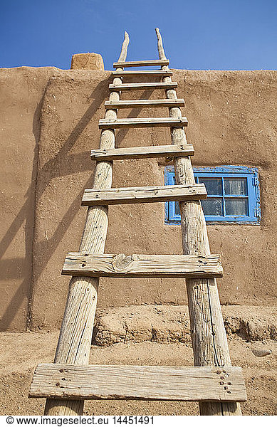 Wooden Ladder Against an Adobe Building
