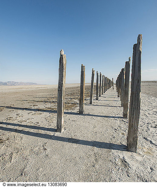 Wooden posts at Great Salt Lake against clear sky