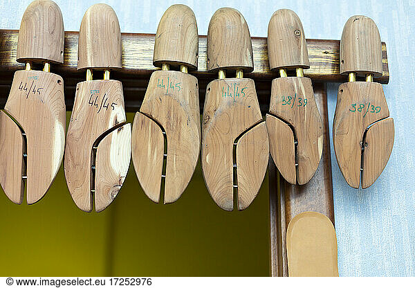 Wooden shoe stretchers hanging in workshop