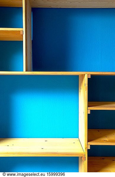Wooden storage shelves with blue wall background modern interior home close.