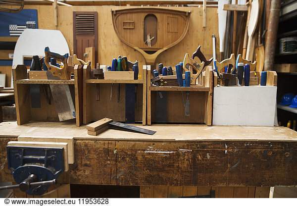 Work bench in a boat-builder's workshop  selection of hand tools for wood working.