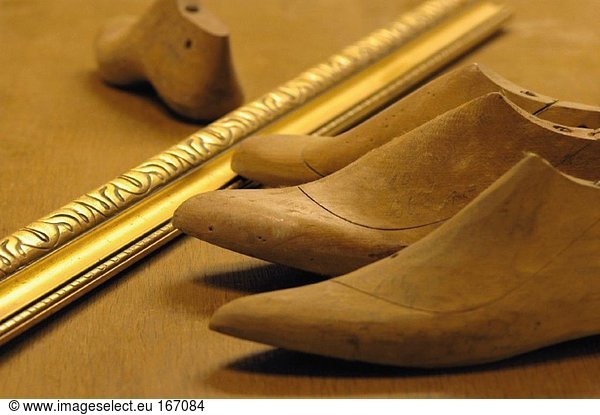 Work tools of shoemaker on wooden surface