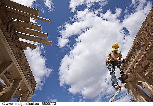 Worker constructing roof beams