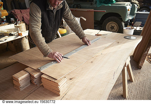 Worker measuring wood