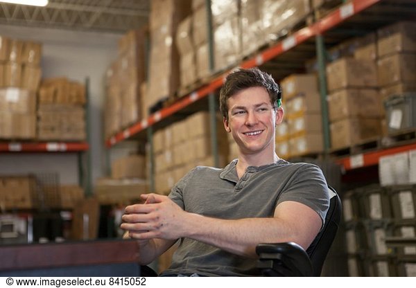 Worker sitting in warehouse