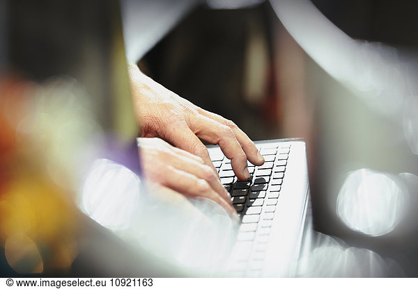 Worker typing on computer keyboard in steel factory