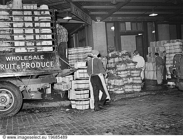 Workers loading green vegetables at produce market  Pier 29  New York City  New York  USA  Arthur Rothstein  U.S. Farm Security Administration  April 1939