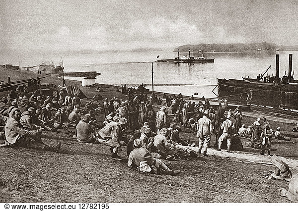 WORLD WAR I: PRISONERS. Austrian prisoners of war enjoying their midday meal at a Serbian port on the Danube during World War I. Photograph  c1916.