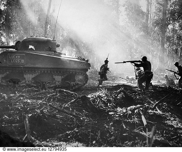 WORLD WAR II: BOUGAINVILLE. American soldiers advancing behind a tank on the Japanese-held island of Bougainville. Photograph  1943.