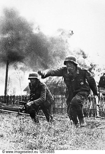 WORLD WAR II: NAZI SOLDIER. A German soldier hurling a grenade in a Russian village  October 1941.