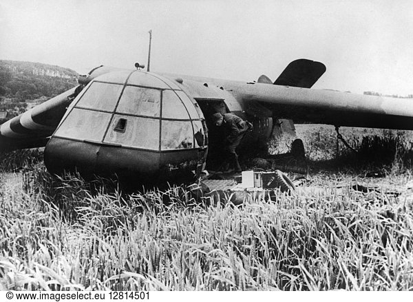 WORLD WAR II: NORMANDY. A German soldier inspects a shot down Allied glider in Normandy following the D-Day invasion June 1944.
