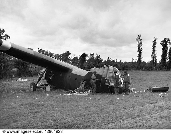 WORLD WAR II: PLANE CRASH. American troops of the 82nd Airborne examine the remains of a Airspeed Horsa glider that crashed during the D-Day invasion of Normandy  June 1944.