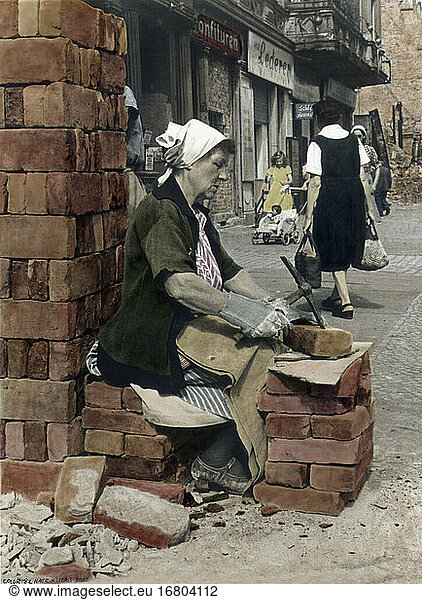 World War II  Post-War Germany. Truemmerfrau at work (rubble woman)
at Berlin. Photo  coloured later.