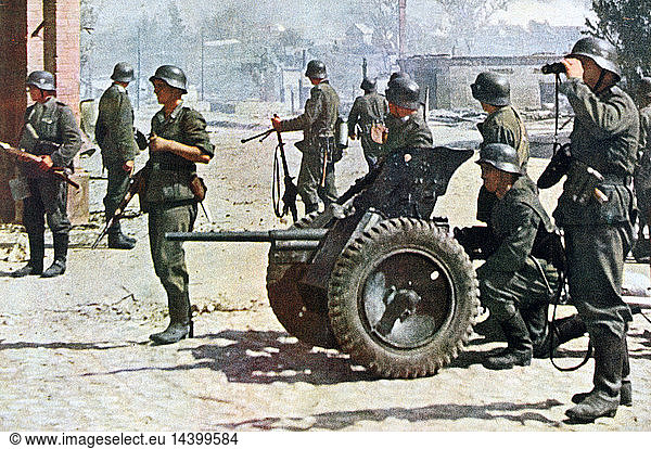 World War II - Russian Front: Helmeted German soldiers searching a ruined village. The man behind the field gun is ready for action and the other troops are on their guard. From "Signal" German propaganda magazine January 1943.